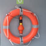 where should fire extinguishers be stored on a boat