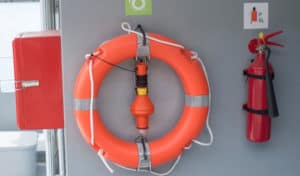 where should fire extinguishers be stored on a boat