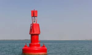 when returning to port from seaward and you see a red buoy how should you respond
